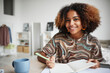 © Seventyfour - Portrait of smiling African-American girl studying at home and smiling at camera, copy space