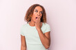 © Asier - Young latin transsexual woman isolated on pink background yawning showing a tired gesture covering mouth with hand.