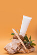 Modern still life scene in neutral colors with white tube toothpaste and  bamboo toothbrush and stones Eco-friendly concept 
