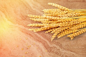 Wall Mural - Pile of wheat spikelets on the wooden desk