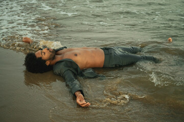 young attractive and sexy black afro American man on the beach