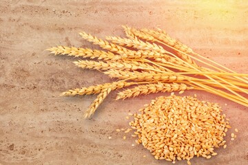 Wall Mural - Pile of wheat spikelets on the wooden desk