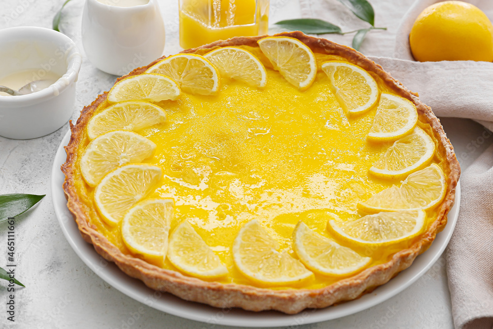 Plate with tasty lemon pie on light background, closeup