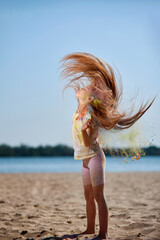 child girl waves her hair with holy powder