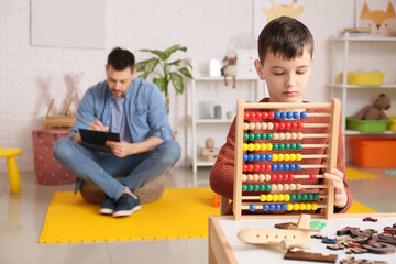 Poster - Little boy with autism spectrum disorder at psychologist's office