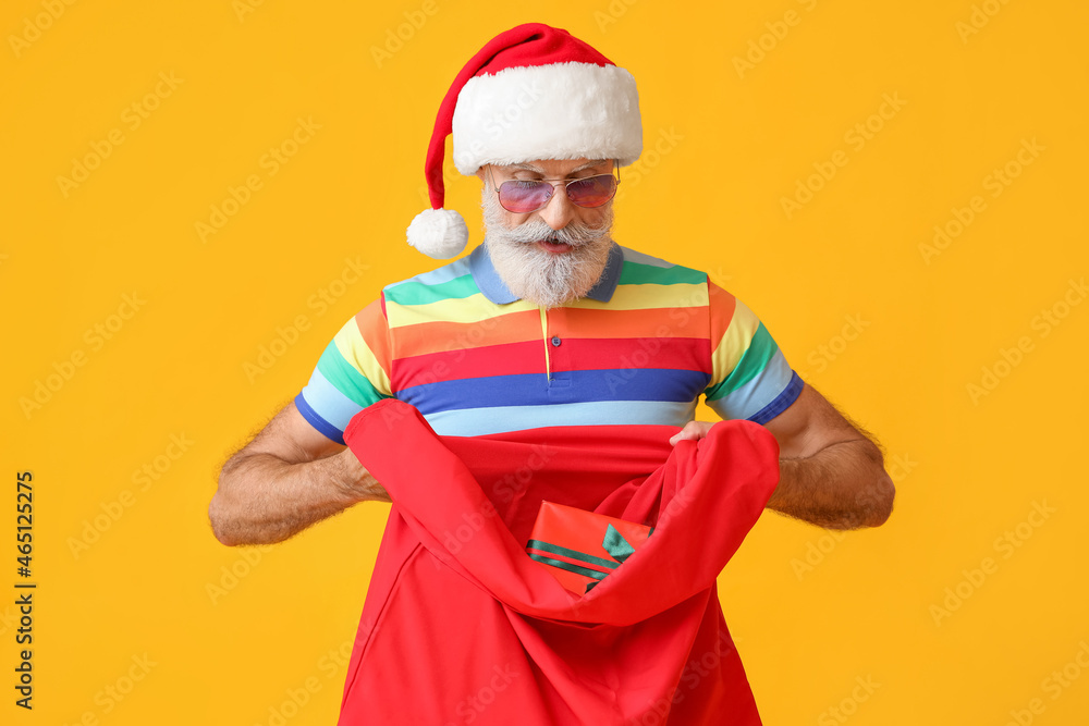 Cool Santa Claus with bag on color background