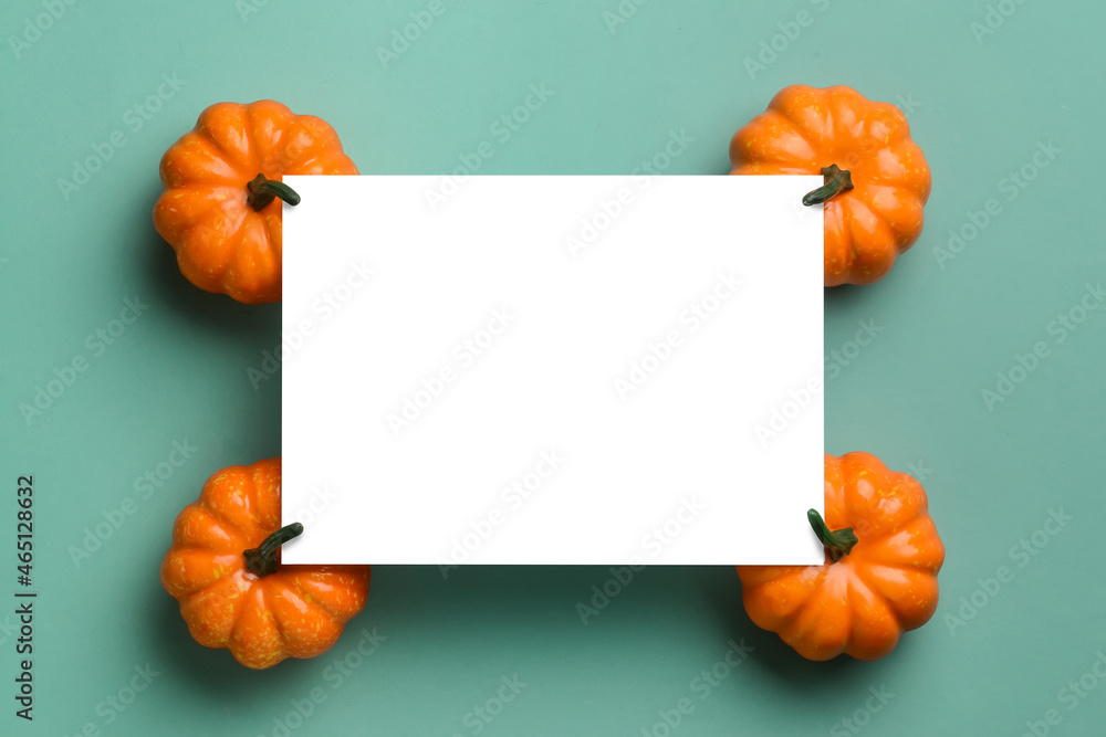 Blank paper sheet with pumpkins on blue background