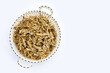Dried anchovy in basket on white background