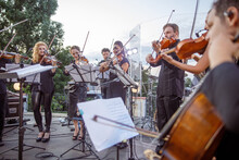 Violin Players Playing Classic Instrumental Music On Outdoor Stage