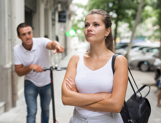 Wall Mural - Young woman offended on her boyfriend during promenade in city