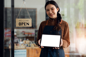 	
Portrait of Smiling young business owner showing blank laptop computer screen,blank copy space screen for your advertising text message in office, Back view of business women,