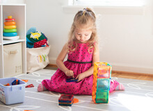 Little Child Playing With Magnet Tiles. Toddler Caucasian Girl Playing.