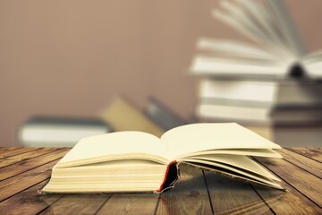 Wall Mural - open book on old wooden table in the library