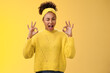 Okay I got it. Cute reliable truthful african-american girlfriend assuring friend secret safe winking devious hinting work done okay show ok fine perfect gesture no worry about, yellow background