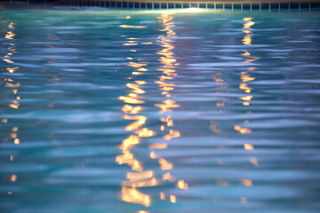 Closeup surface of blue clear water with small ripple waves in swimming pool.