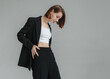 Fashion shot of stylish vogue woman in black suit in studio