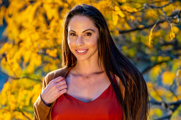 Wall Mural - A Lovely Brunette Model Poses Outdoor While Enjoying The Fall Weather