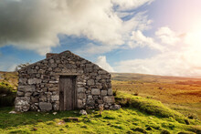 Old Abandoned Stone House Without The Roof. Sunset Time. Rural Irish Farm Building. Dramatic Sky. Old Architecture Example. Top Quality Frame . History And Heritage Concept. Connemara, Ireland