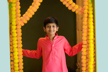 Wall Mural - Indian little boy in traditional wear and celebrating diwali festival.