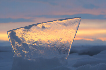 Wall Mural - A piece of ice of Lake Baikal, colored by sunset