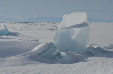 Wall Mural - Piece of ice against the background of mountains and Lake Baikal