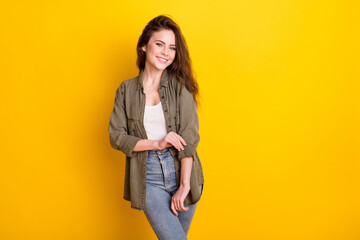 Sticker - Photo of adorable sweet young lady wear brown shirt adjusting clothes empty space isolated yellow color background