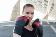 © Westend61 - Serious female athlete with boxing glove