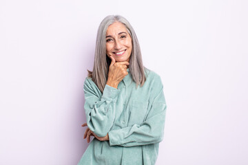 Wall Mural - middle age gray hair woman smiling, enjoying life, feeling happy, friendly, satisfied and carefree with hand on chin