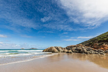 Sky Over Sandy Coastal Beach In Summer With Boulders In Background, Australia