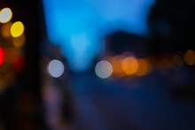 Blur Texture Background For Design. Out Of Focus Views Of The City Streets In The Evening And At Night. Cars And Roads, Headlights And Colored Lights.