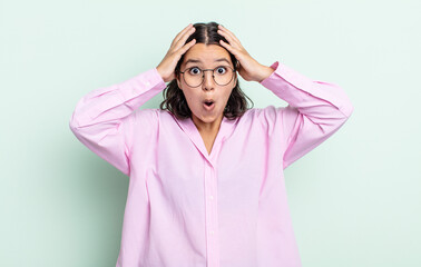 Wall Mural - pretty teenager woman feeling horrified and shocked, raising hands to head and panicking at a mistake