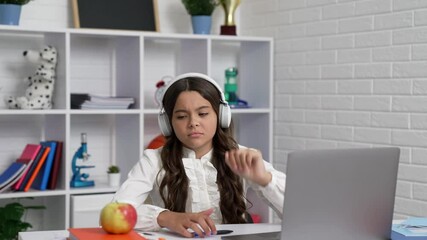 Wall Mural - sleepy bored kid staring to play with apple at lesson online in headphones, elearning