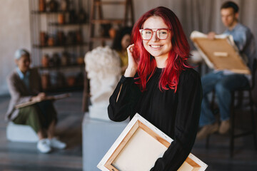 young student woman smiling at camera during class in art school