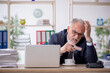 © Elnur - Old male employee feeling bad at workplace
