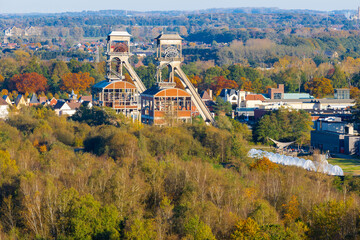 Two former coal mine elevators rising up over the national park Hoge Kempen near the city of Maasmechelen. The mine area is converted into a tourist domain with hiking routes.