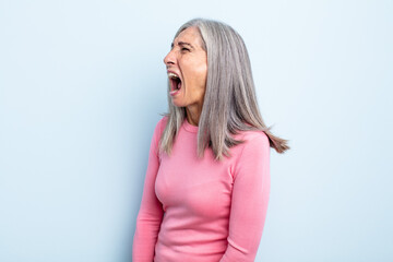 Wall Mural - middle age gray hair woman screaming furiously, shouting aggressively, looking stressed and angry