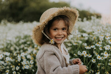 Smiling Girl With Flower In Hat At Agricultural Field