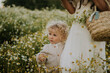 © Westend61 - Baby boy with mother at flower field