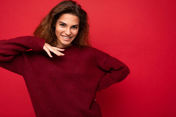 Wall Mural - Photo shot of pretty joyful smiling young female person wearing casual trendy outfit standing isolated on colourful background with copy space looking at camera and having fun