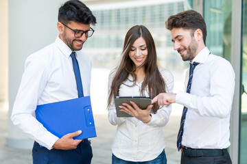 Wall Mural - Business people using a tablet outdoor