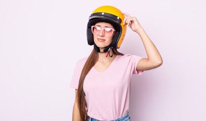 Poster - young pretty woman with a motorbike helmet.