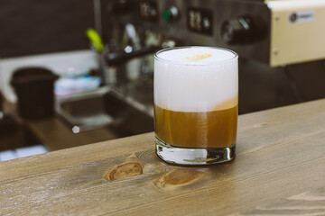 Wall Mural - glass of coffee on a wooden table selected focus