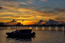 Malaysia. The East Coast Of Borneo. A Blazing Dawn On The Reef Island Of Mabul, Famous All Over The World For Its Diving Clubs.