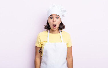 Wall Mural - pretty young woman looking very shocked or surprised. chef concept