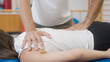 © 24K-Production - Physiotherapist's hands doing medical back massage, to a female patient, during a rehabilitation treatment.