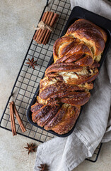 Wall Mural - Cinnamon babka or swirl brioche bread. Cinnamon roll bread. Povitica: traditional Polish sweet bread. Homemade pastry for breakfast. Top view.