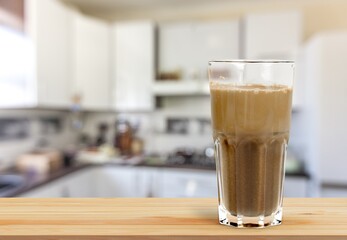 Poster - Latte coffee in a beautiful cup, foamy coffee and milk drink in a transparent glass cup.