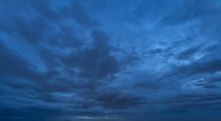 Wall Mural - Dramatic dark blue clouds sky with thunder storm and rain at night. Abstract nature landscape background.