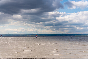 Wall Mural - Surfer bei wildem Wolken und Wetter auf dem See