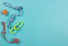 Colorful Cotton Rope Toys For Cat Puppy Dog On Light Blue Background. Top View, Copy Space